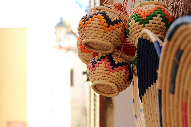 Traditional sardinian craft Close-up on a basket made with asphodel straw, a traditional sardinian handicraft, shot on the street of Castelsardo. castelsardo photos stock pictures, royalty-free photos & images