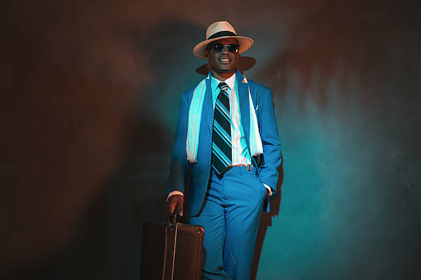 istock African american traveller in blue suit wearing straw hat. 486778616