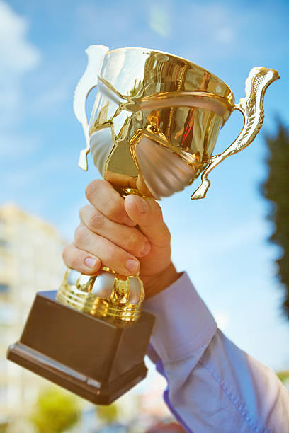 istock Showing cup of winner 486778786