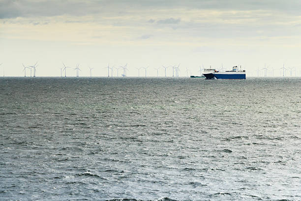 istock Ferry and windmills in ocean sustainable industry 486778900