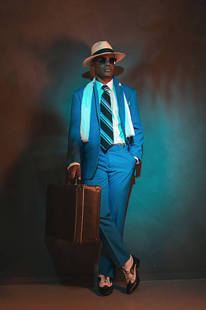 istock African american traveller in blue suit wearing straw hat. 486778976