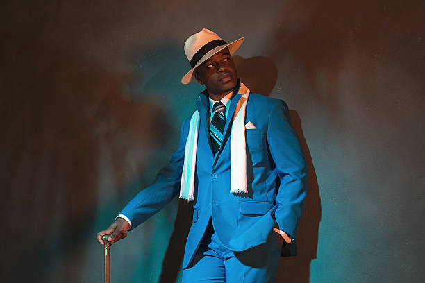 istock African american dandy man in blue suit and straw hat. 486779698