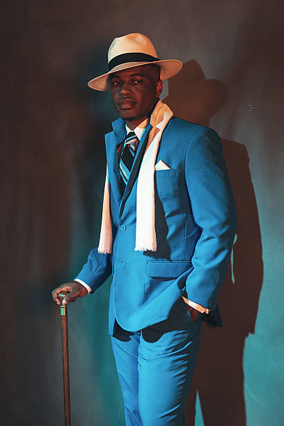istock African american dandy man in blue suit and straw hat. 486779822