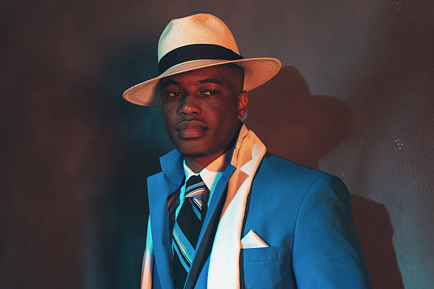 istock African american dandy man in blue suit and straw hat. 486779974