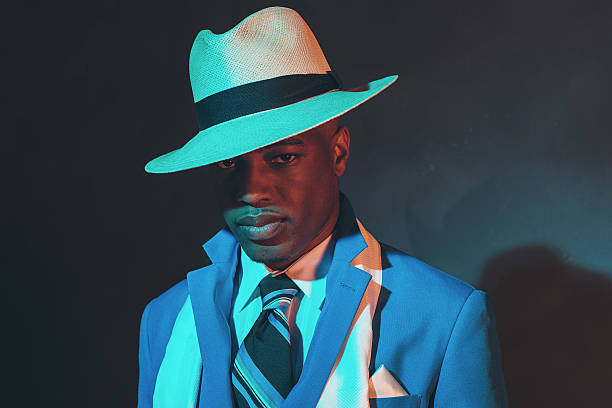 istock African american dandy man in blue suit and straw hat. 486780174