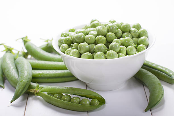 istock Fresh green peas in a white bowl  . 486781304