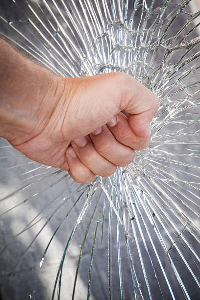 istock Strong male fist with broken glass 486781700
