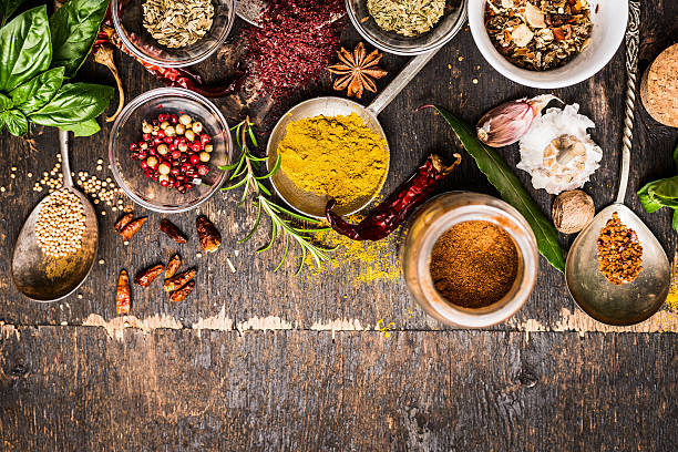 Bowls and spoon of  Various spices selection on rustic background stock photo