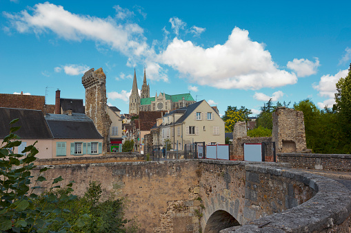 Cityscape of Chartres, France, with famous cathedral on the background and ancient bridge on the foreground