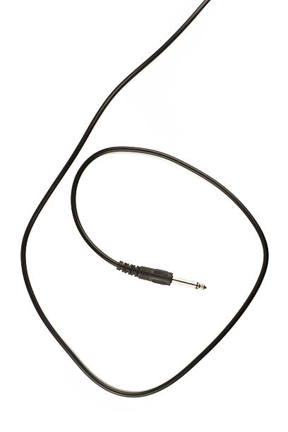 istock Guitar audio jack with black cable isolated on white background 486784500