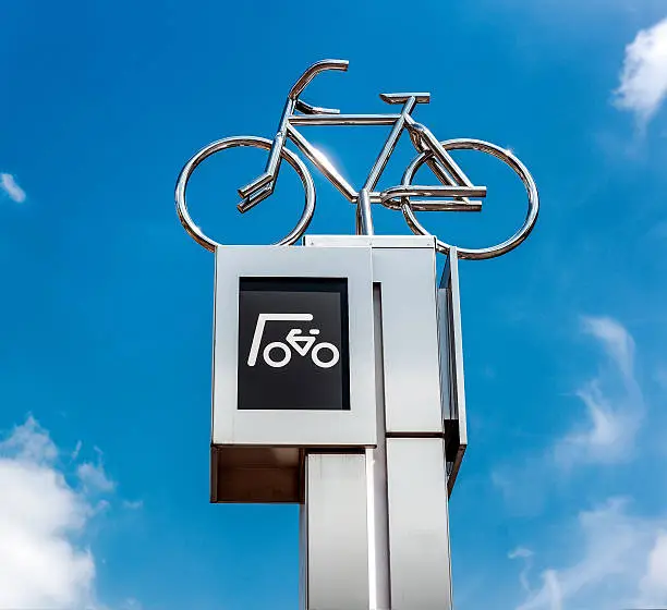 Bicycle parking sign against blue sky background. Eindhoven city center. Netherlands