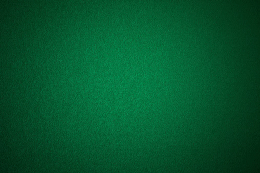 Texture green felt with center soft light.