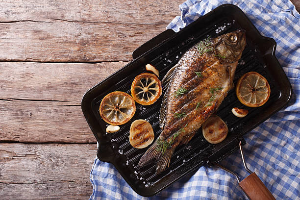 istock Grilled carp with lemon in grill pan , horizontal top view 486788516