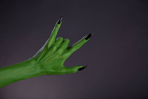 istock Green monster hand showing heavy metal gesture 486788968