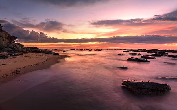 istock Magnificent sunrise high tide at Bateau Bay rockshelf 486789923