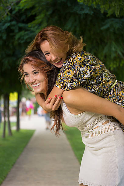 istock Two girls, playing on back of each other. 486789940