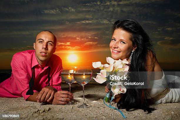 Bride And Groom At Sunset Stock Photo - Download Image Now - Adult, Animal, Beach