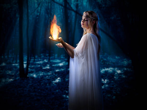 istock Elven girl with fire in night forest 486790876