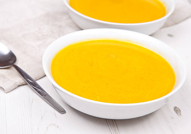 istock Two bowls of carrot soup on the white table 486791305