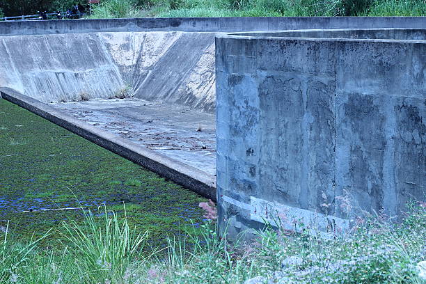 istock Reservoir, built with massive concrete without water 486791518