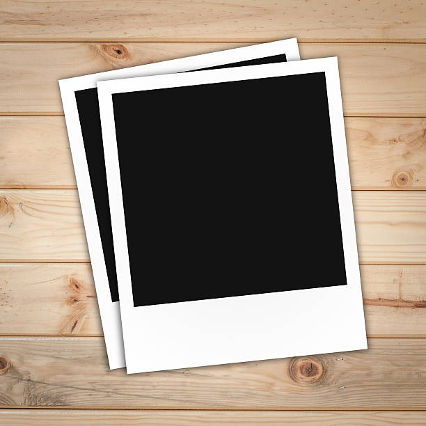 istock blank polaroid photo frame on brown wood plank background 486792597
