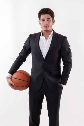 basketball player give pose in black background.
