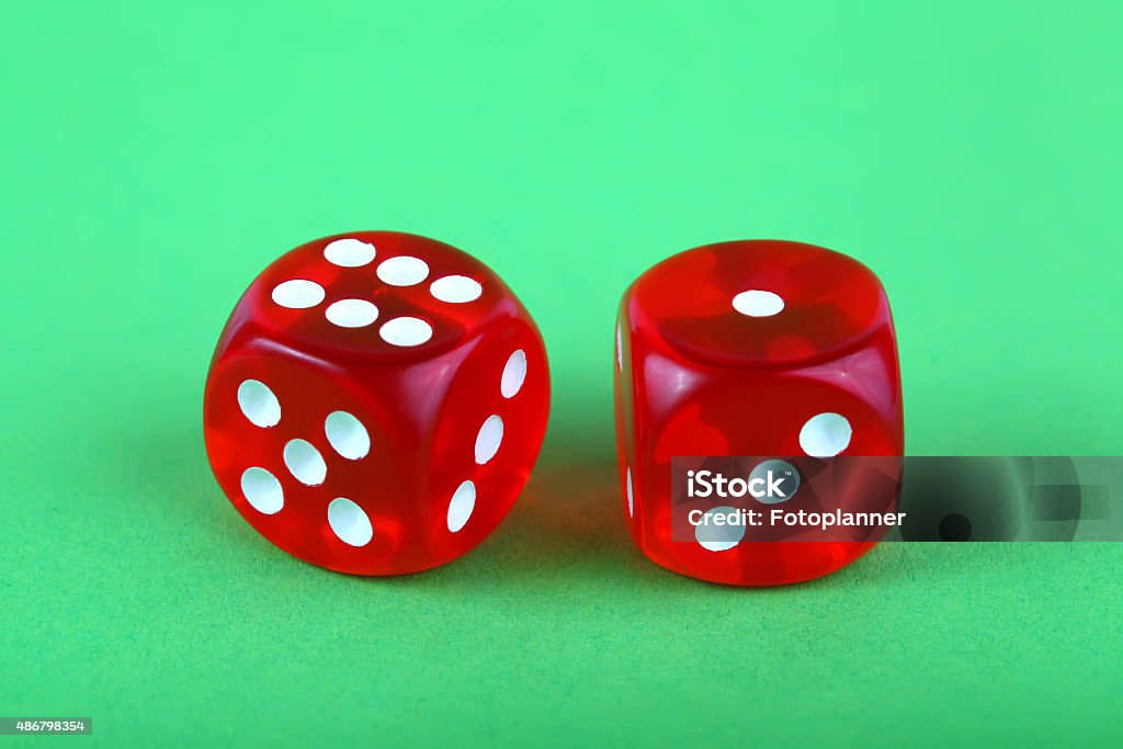 Red dices Red dices on green background 2015 Stock Photo