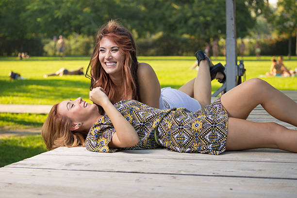 istock Two beautiful girls lying on wooden boards. 486798536