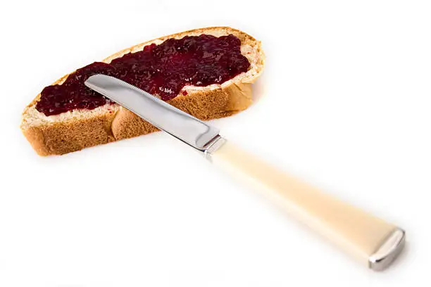Wheat bread slice (yeast braid) smeared with cherry jam
