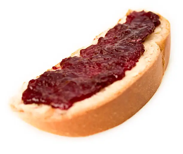 Wheat bread slice (yeast braid) smeared with cherry jam