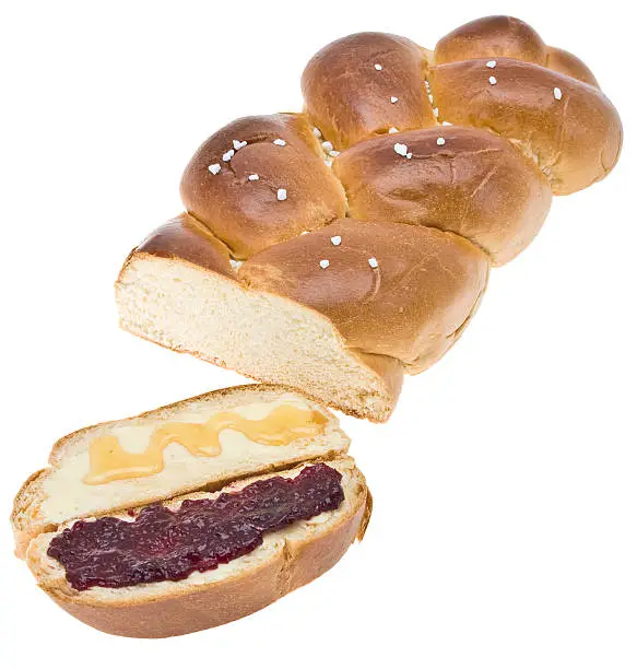Wheat bread slice (yeast braid) smeared with cherry jam and honey