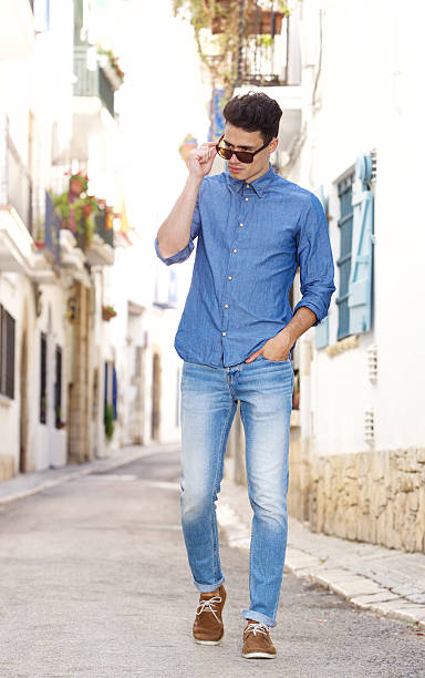 istock Cool young guy walking on street in town 486804796