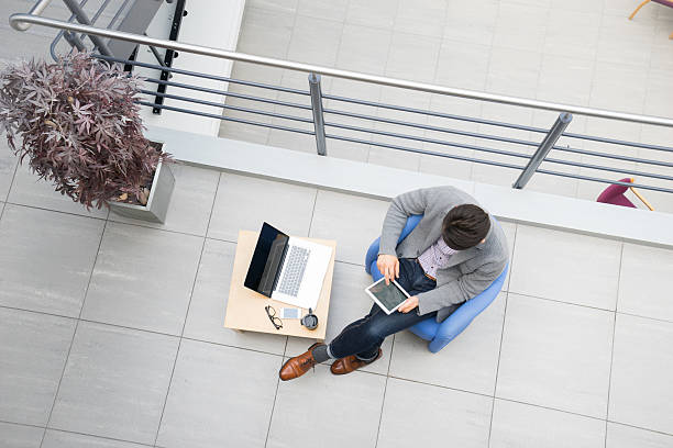 istock Young asian businessman using tablet, mobile phone in the office 486804944
