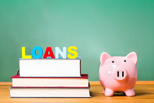 istock Student loan theme with textbooks and piggy bank 486805808