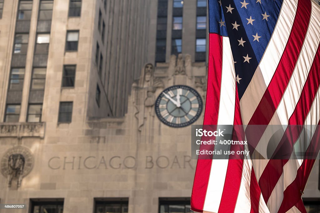 America Сhicago, USA - April 8, 2014: An American flag hanging in front of the Chicago Board Of Trade mid day.  American Flag Stock Photo