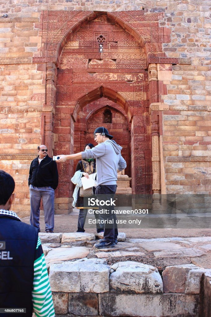 Ancient islamic grave with inscriptions at qutub minar New Delhi, India - February 6, 2013: Tourists visiting ancient islamic grave with inscriptions at qutub minar in Delhi, India. Ancient Stock Photo