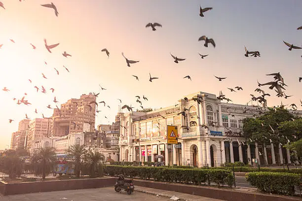 Connaught Place, New Delhi, India during the early morning. Typical Georgian buildings are seen in the front. These are the commercial areas. The famous "Statesman Building" is seen in the background. Shot taken from the inner Circle or Rajiv Chowk.