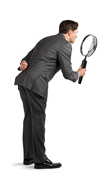 istock Businessman Looking Through Magnifying Glass 486808557