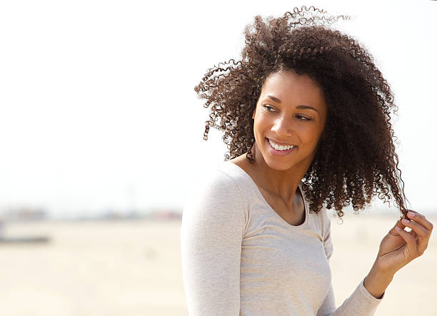 istock Young woman smiling with curly hair 486808691