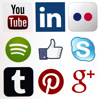 Berlin, Germany - July 16, 2015: Social media icons Facebook, Youtube, LinkedIn, Flickr, Google Plus, Spotify, Skype, Tumblr, Pinterest printed on white paper.