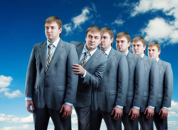 istock Queue of businessmans isolated on sky view 486812175