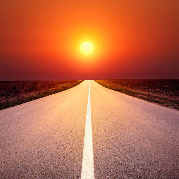 istock Driving on an empty asphalt road at sunset 486812283