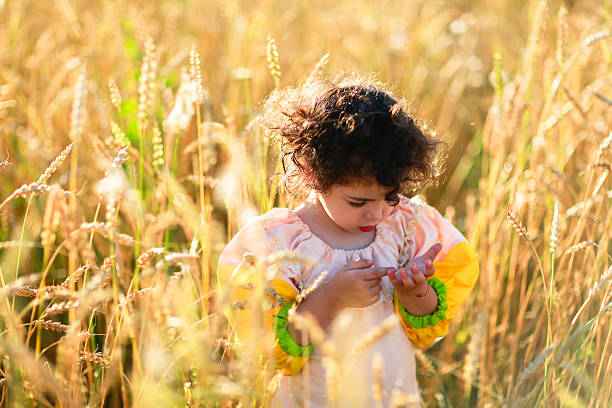 istock child in a field of wheat 486812658