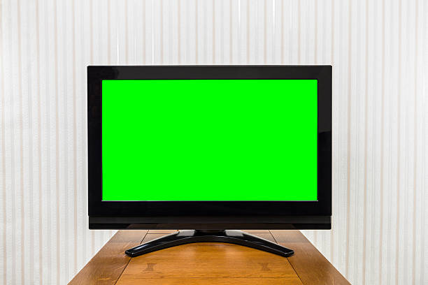 istock Modern Television on Wood Table with Green Chroma Key Screen 486813576