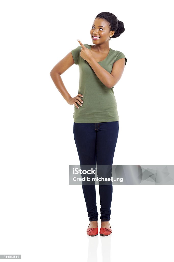 african american woman pointing happy african american woman pointing at empty space Women Stock Photo