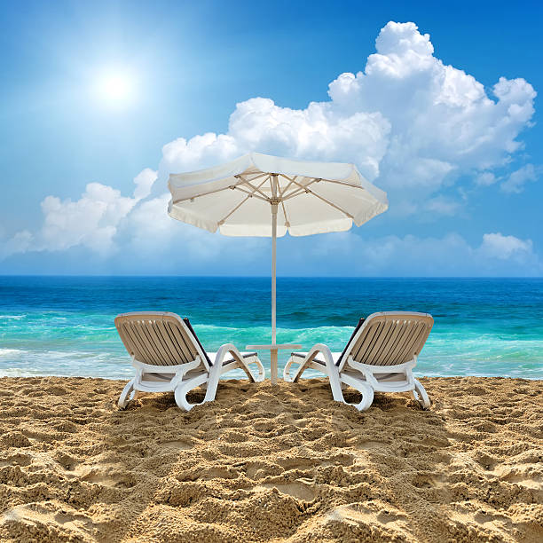 istock Beach chair and white umbrella on beach 486814386