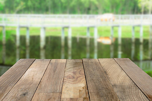 istock Wood table top on Green nature blurred backgrounds. 486814516