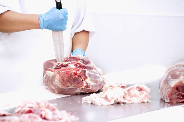 istock butcher cutting meat on the table 486815774