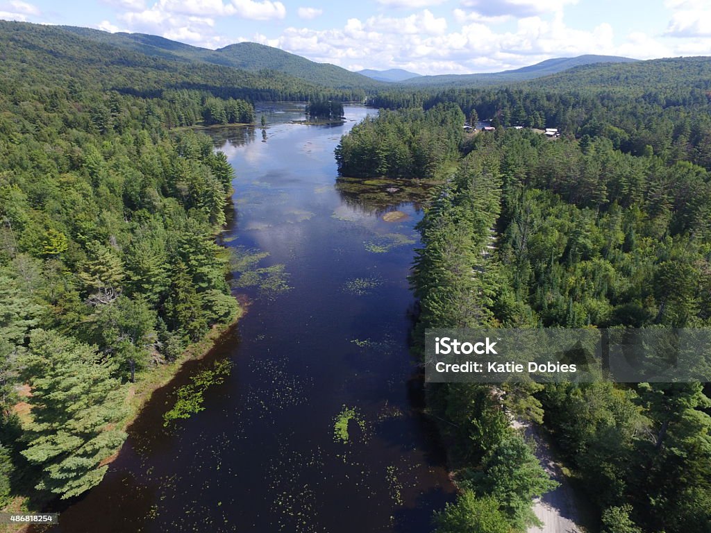 Wilcox Pond, Harrisburg Lake, Stony Creek, Adirondacks, NY, Aerial Drone Harrisburg Lake, Wilcox Pond and Stony Creek decorate this remote area of the Adirondack Park in New York State. Serene views of the lakes and streams with marshlands and vistas makes this area an ideal vacation spot for many activities. Summertime includes swimming, canoeing, kayaking, hiking, atv riding, horseback riding, fishing, camping and more. This area is a popular hunting spot for big game like bear and deer. In the wintertime you will find snowmobilers, cross country skiers, and warm fires at a local resort nearby. Photographed using camera attached to DJI Phantom 3 Professional Drone. 2015 Stock Photo