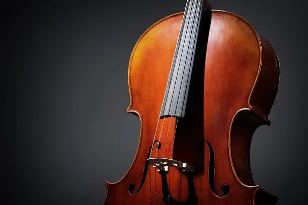 Antique Cello musical instrument on a dark background